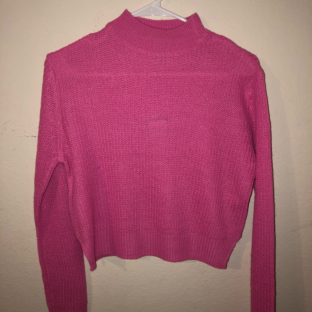 A pink long sleeve turtle neck